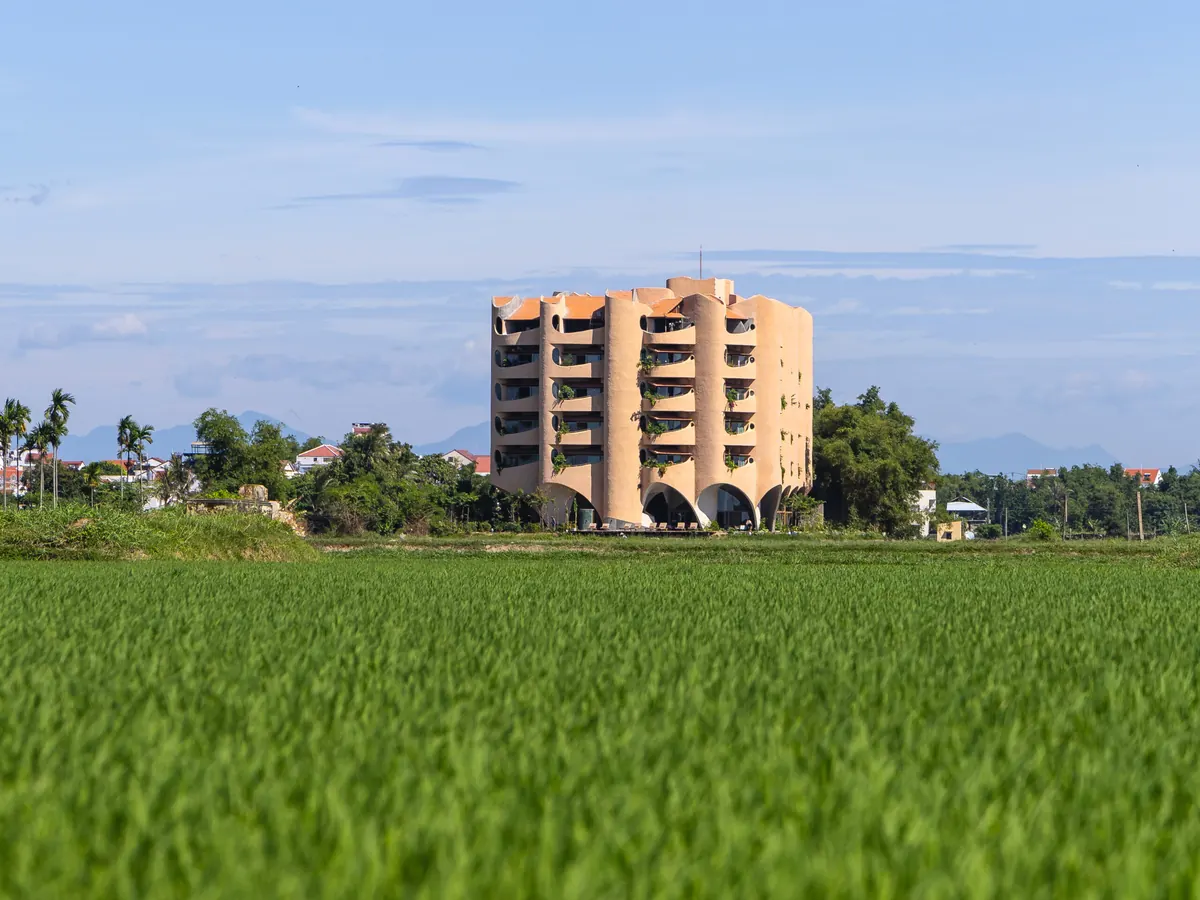 Facade of Reu Boutique Hotel with its riverside garden in Hoi An